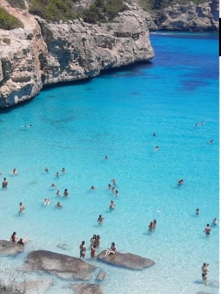 Rocky cove and clear blue water at Caló des Moro